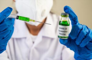 Scientists wearing masks and gloves Holding a syringe with a vac